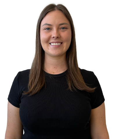 A woman with straight brown hair, wearing a black short-sleeve shirt, smiles whilst standing against a plain white background.