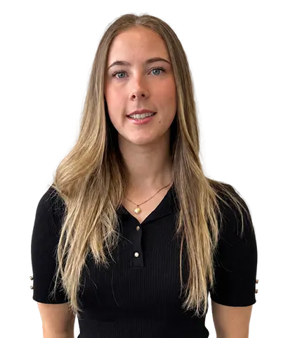 A woman with long blonde hair smiles at the camera. She is wearing a black short-sleeved knit top and a gold necklace against a plain white background.